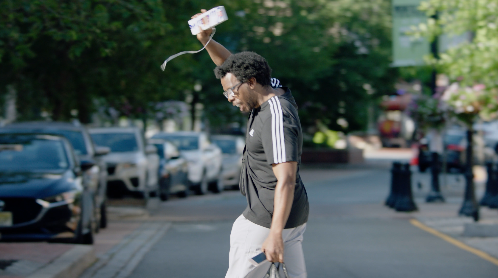 Man happily grabbing a box of Bahlsen leibniz from a drone