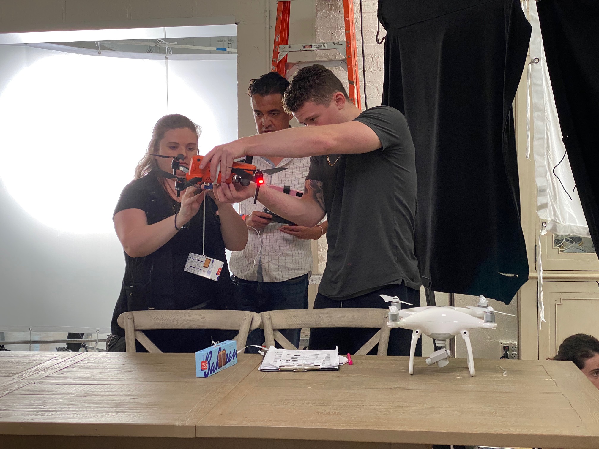 Event coordinators working on attaching boxes of Bahlsen leibniz to a drone