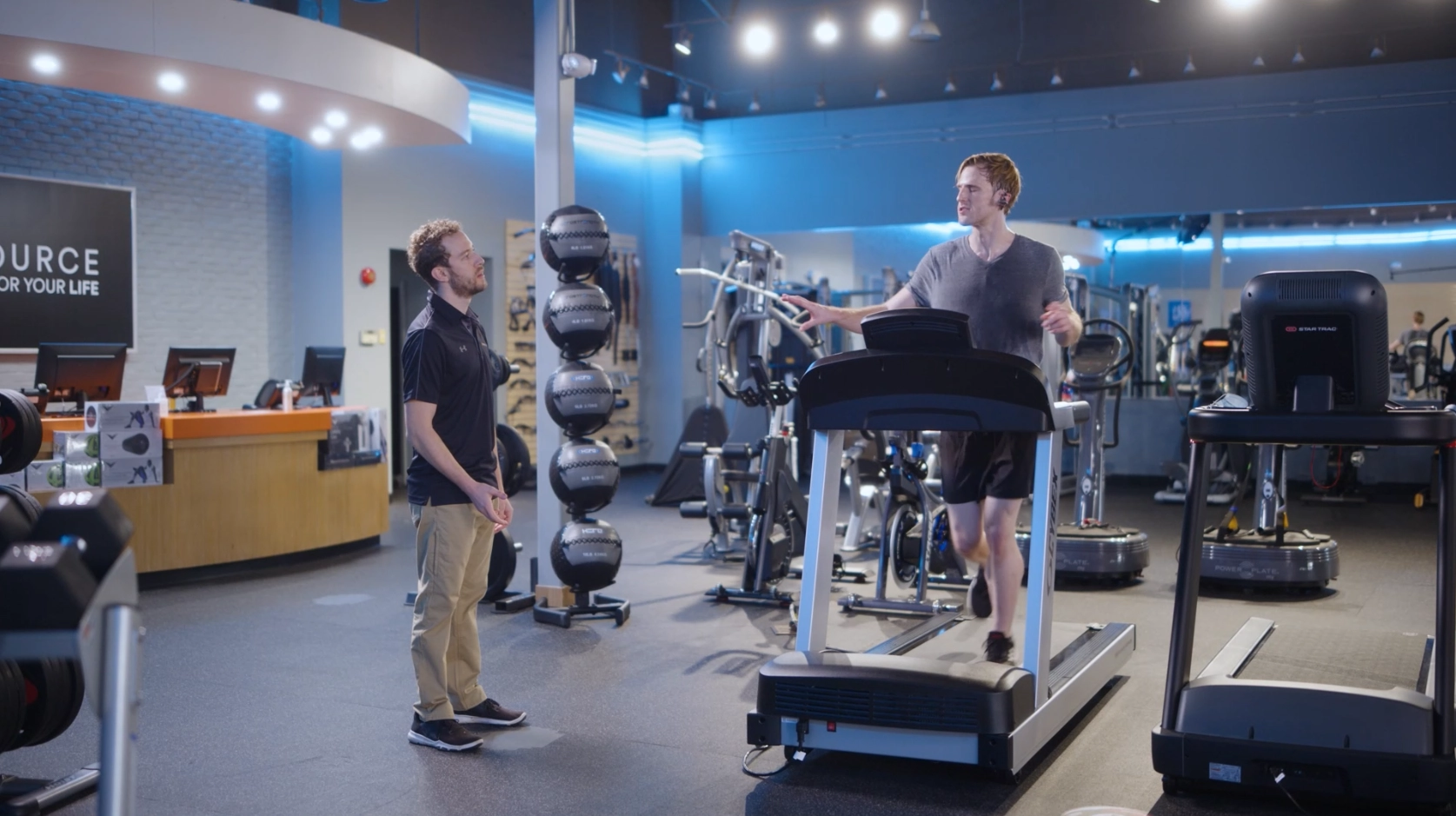 Modern home gym setup with premium fitness equipment including treadmill and weight machines