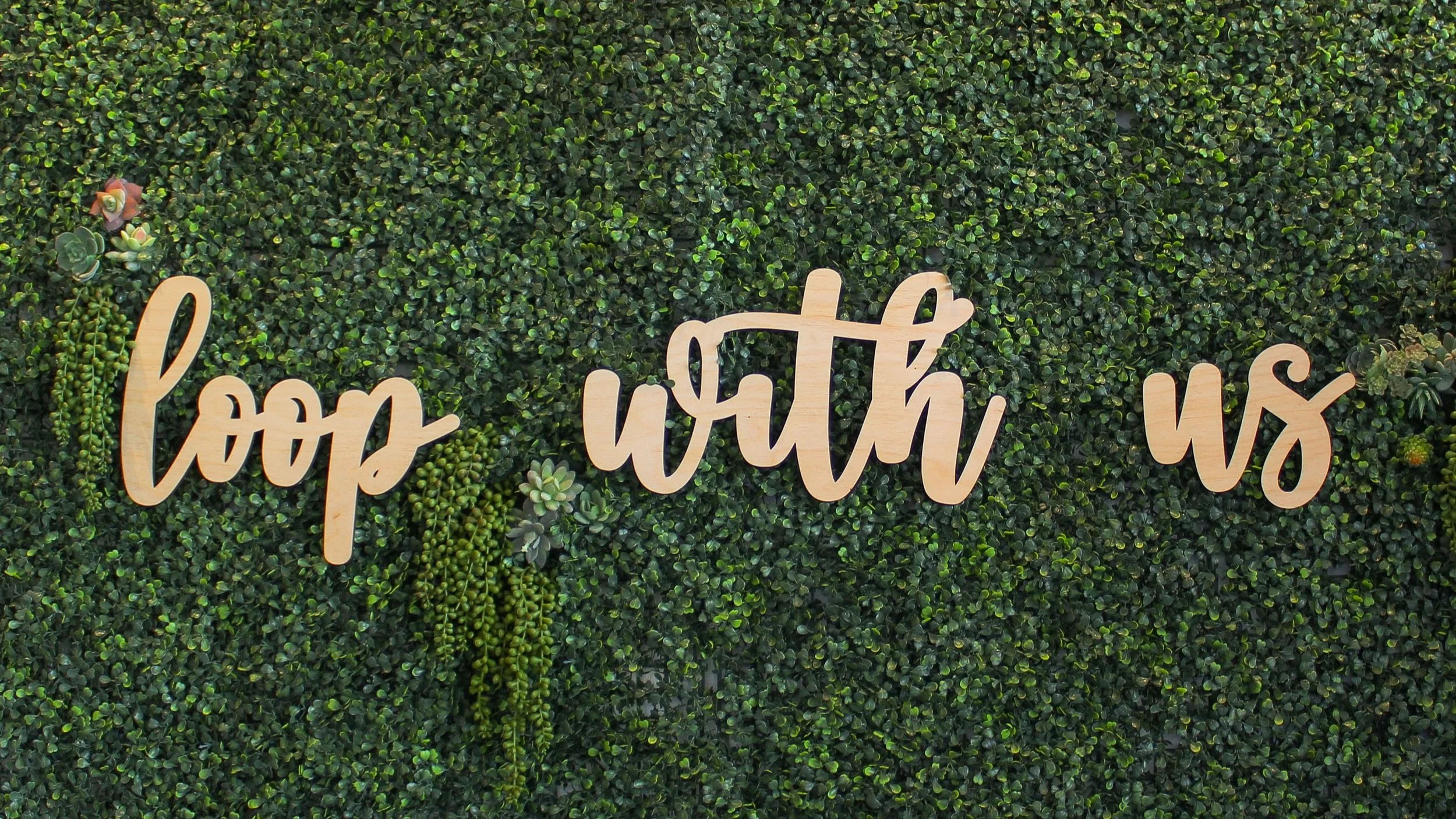 Loopwell slogan 'loop with us' on an organic fern backdrop